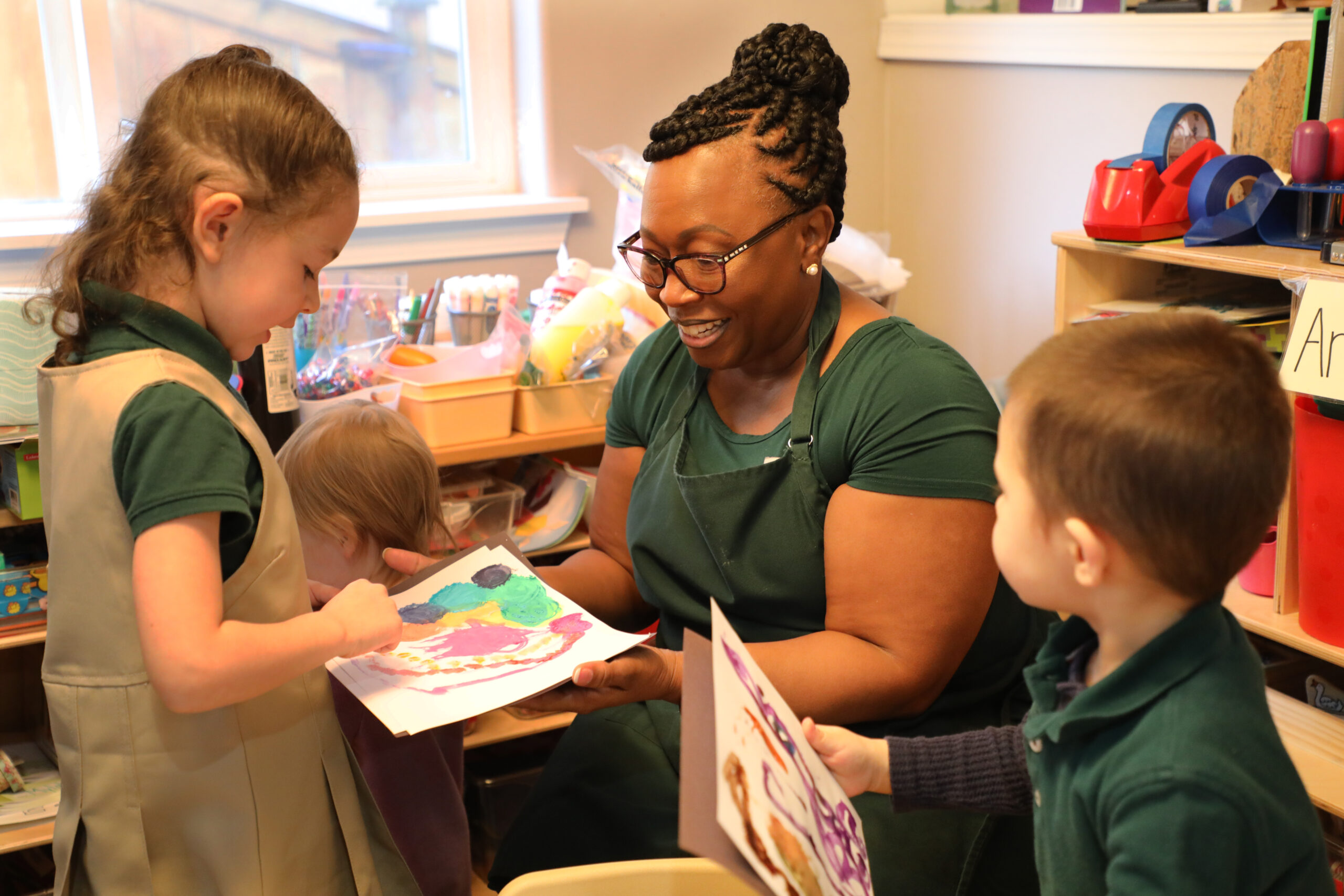 Teacher Mary Curry, a Black woman, reads a picture book to her young students during story time.