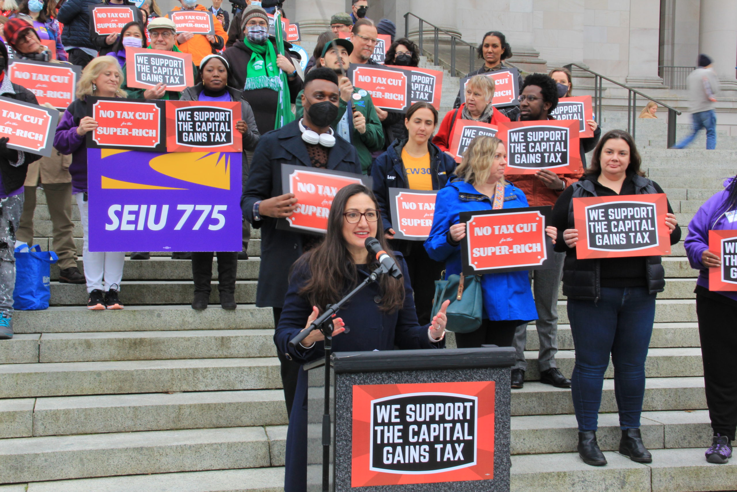 Treasure Mackley, Executive Director of IWN, speaks at rally in Olympia. Washingtonians and advocates stand behind her.